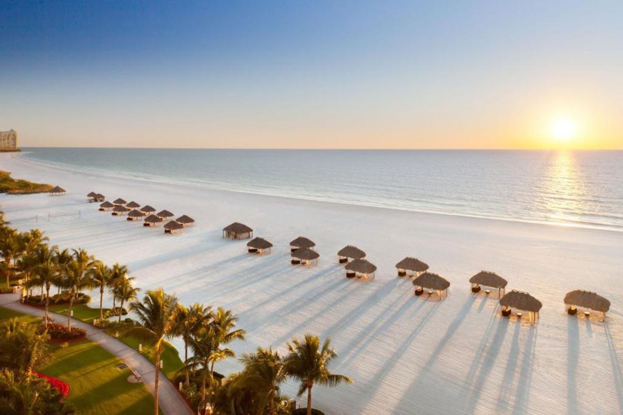 white sand beaches with chairs and umbrellas out at the JW Marriott Marco Island Hotel